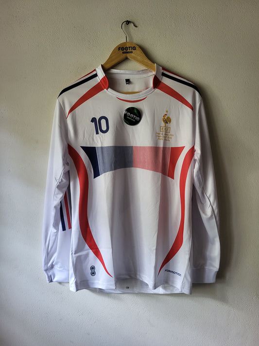 A white long-sleeve France soccer jersey with red and navy graphic stripes, featuring the number 10 on the chest, hanging on a wooden hanger against a plain beige wall.