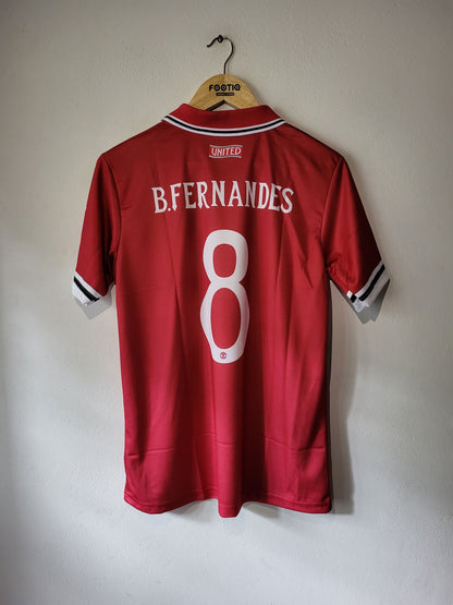 A red short-sleeve soccer jersey hanging on a wooden hanger against a plain wall. The back of the shirt shows 'B.