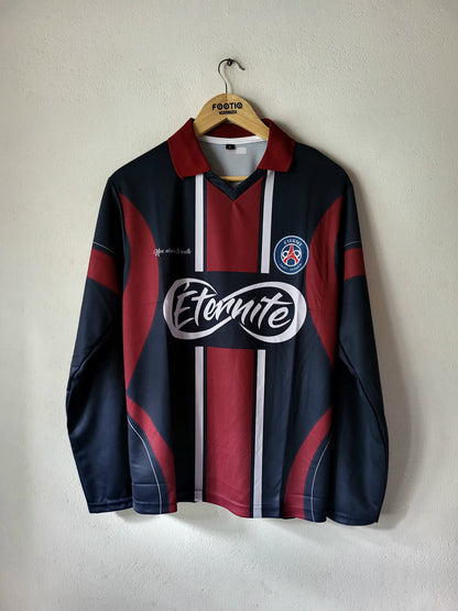 A vintage FC Barcelona long-sleeve soccer jersey in navy blue and maroon, featuring white vertical stripes down the center, a large white 'Etnaite' sponsor logo across the chest, and the club's crest on the left chest. The jersey is hanging on a wooden hanger with 'Festa' printed on it, against a plain off-white wall.