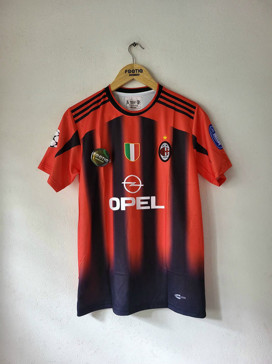 A red and navy striped AC Milan soccer jersey hanging on a wooden hanger against a plain wall. The jersey features the OPEL sponsor logo on the front, the AC Milan club crest, and the Adidas logo on the collar.