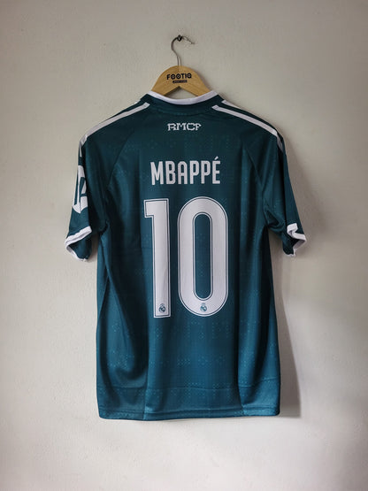 A dark teal FC Copenhagen soccer jersey with 'MBAPPÉ 10' printed on the back, hanging on a wooden hanger against a plain off-white wall.
