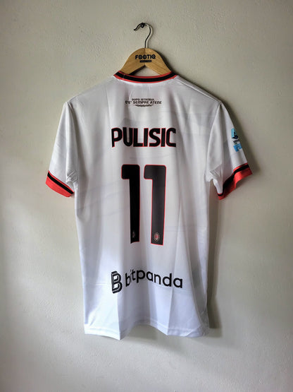 A white FC Copenhagen football jersey with 'PULISIC 11' printed on the back, hanging on a wooden hanger against a plain wall.