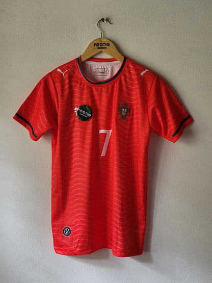 A red Puma soccer jersey with black and white accents, featuring the number 7 on the front, laid flat on a light beige wall.