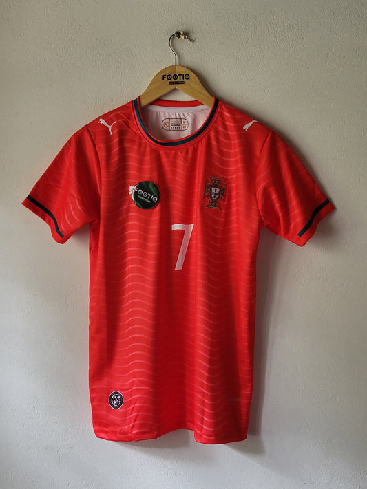 A red Puma soccer jersey with black and white accents, featuring the number 7 on the front, laid flat on a light beige wall.